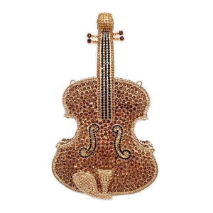 Macro shot of violin-shaped evening clutch with detailed brown and gold rhinestones
