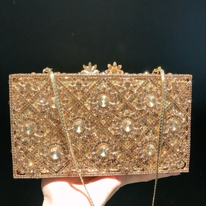 Golden hard shell evening clutch with sunflower rhinestone patterns and chain strap