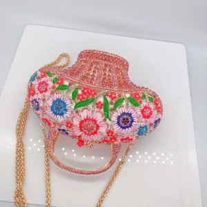 Détail de la pochette de soirée en forme de chapeau avec fleurs en émail et strass roses