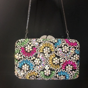 Elegant rectangular evening clutch featuring colorful floral rhinestones and silver chain