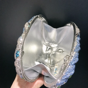 Detail of blue rhinestone clutch with silver chain and metallic lining