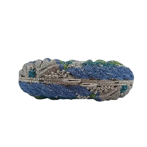 Detail of blue and green crystals on the elegant evening clutch bag with wave patterns