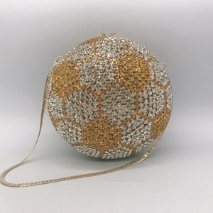 Close-up of sparkling gold and silver rhinestones on the football evening clutch bag