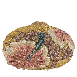 Detailed close-up of floral rhinestone pattern on gold evening clutch bag with blue gems