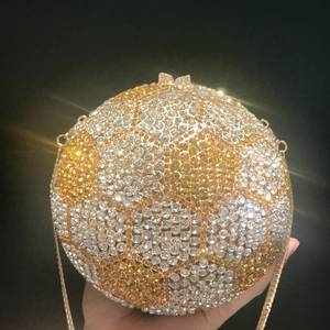 Close-up of sparkling soccer-shaped evening bag with yellow and white rhinestones