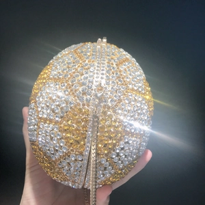 Close-up of sparkling rhinestone-encrusted basketball evening bag with a gold chain strap