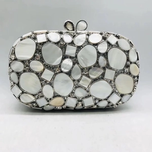 Detail of shell clutch with pearl inserts, silver mesh, and butterfly clasp closure