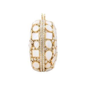 Detail of shell clutch bag with gold metal frame and sparkling crystal accents