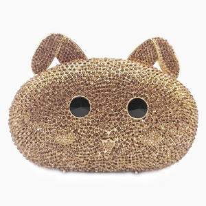 Detailed macro view of luxurious rabbit clutch bag with sparkling golden crystals