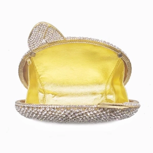 Macro view of crystal encrusted cat shape evening bag showing gold leather interior lining