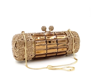 Detail of luxury gold cylinder clutch bag with amber crystals and fine metal chain