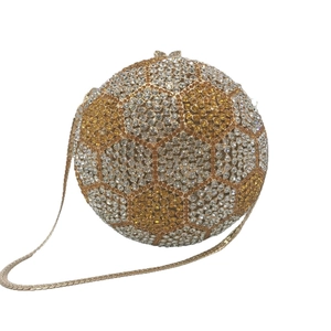 Sparkling soccer-shaped evening clutch bag with gold and white rhinestones and chain strap