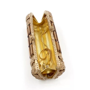 Detail of luxury evening clutch with gold rhinestones and brown crystals in open view