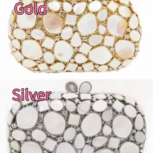 Luxury shell clutch in gold and silver finish with hollow metal and sparkling diamonds