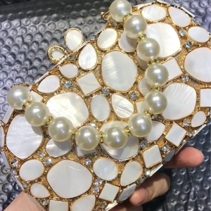 Elegant gold shell evening clutch bag with sparkling diamonds and pearl handle for women