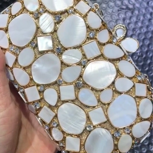 Exquisite shell-patterned gold metal clutch bag with diamond accents and shell inlay