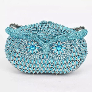Close-up of royal blue owl evening clutch bag with sparkling rhinestones and crystal eyes