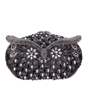 Close-up of sparkling owl clutch bag with detailed black and grey rhinestone crystals