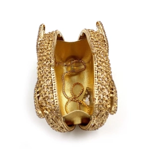 Interior view of gold owl evening bag showing metal lining and chain strap