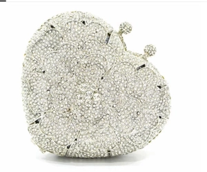 Detailed close-up of sparkling heart-shaped clutch with layered floral crystal petals