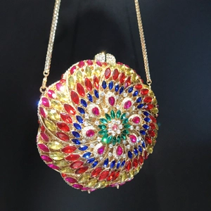 Macro detail of colorful floral rhinestone pattern on circular evening clutch bag