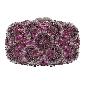 Macro detail of mandala rhinestone patterns and crystal encrusted evening clutch bag