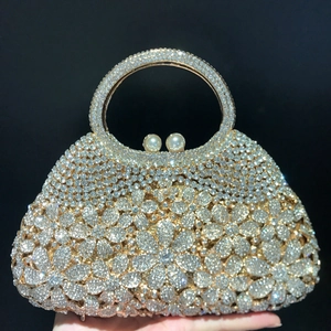 Detail of luxury rhinestone evening clutch bag with crystal daisy pattern and pearl clasp