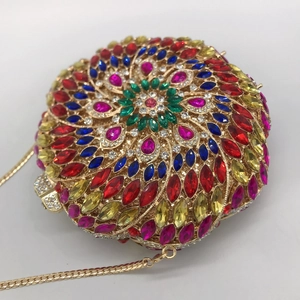 Macro shot of colorful rhinestones on a round evening clutch with floral patterns
