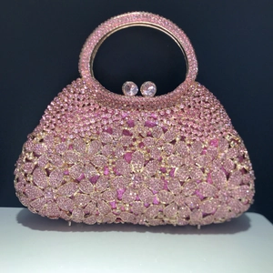 Pink rhinestone evening bag with floral crystal pattern and sparkling round metal handle