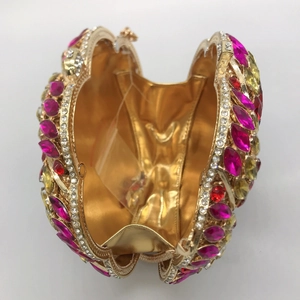 Detail of luxury colorful rhinestone evening clutch with gold lining and hinged frame