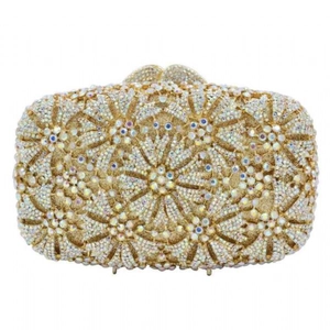Macro detail of dandelion hollow pattern with crystals on gold evening clutch bag