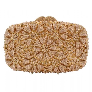 Detailed close-up of champagne gold evening clutch with hollow floral rhinestone patterns