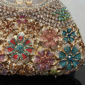 Macro detail of luxury floral evening clutch showing colorful rhinestones and crystal patterns