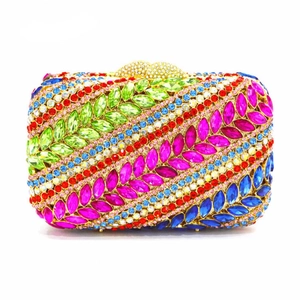 Macro detail of multicolored crystals and gold heart clasp on a luxury evening clutch bag