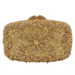 Macro shot of gold evening clutch featuring symmetrical rhinestone flower pattern detail