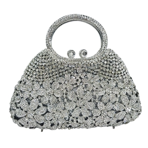 Elegant silver evening clutch bag featuring floral rhinestone patterns and round handle
