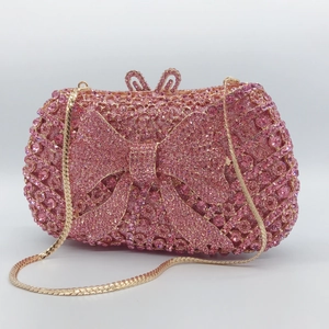 Elegant pink rhinestone evening clutch bag with bow design and gold metal chain strap