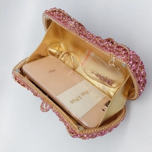 Pink rhinestone clutch interior showing capacity for an iPhone with golden chain strap