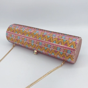 Detailed macro view of colorful geometric rhinestone patterns on a luxury cylinder clutch