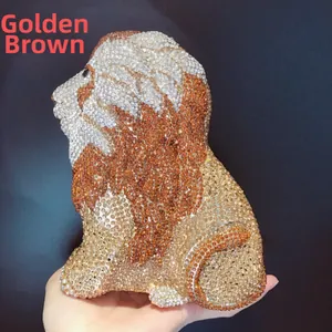 Detailed close-up of golden brown lion-shaped evening clutch encrusted with sparkling rhinestones