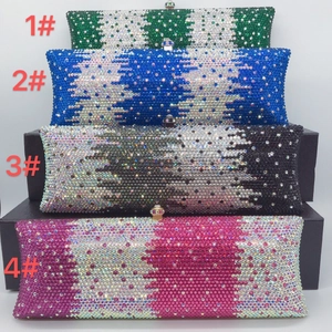 A collection of four handmade rhinestone evening clutch bags in vibrant colors