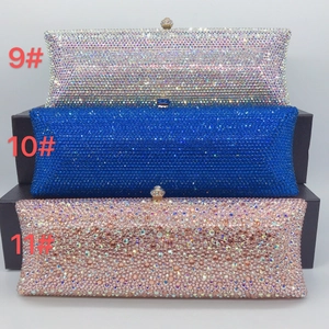 Three elegant crystal clutch bags in silver, royal blue, and rose gold with diamond clasps