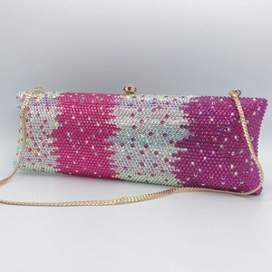 Detail of colorful rhinestones on a rectangle evening clutch bag with gold chain