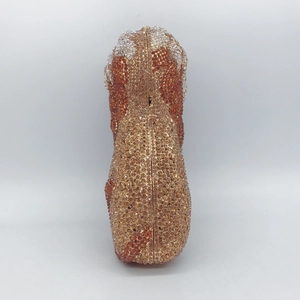 Detail view of lion-themed evening clutch with champagne and orange crystal patterns