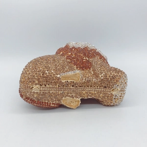Macro view of crystal-encrusted bulldog evening bag showing intricate rhinestone handwork