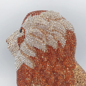 Macro shot of detailed lion shape evening bag featuring white and orange rhinestones