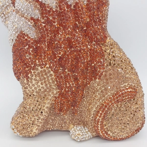 Detail of lion evening bag showing intricate champagne and amber rhinestone arrangement