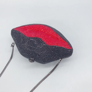 Detailed view of luxury red and black lip shaped clutch with shimmering rhinestones
