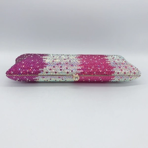 Close-up of luxury rectangular clutch with pink and white crystal rhinestone mosaic