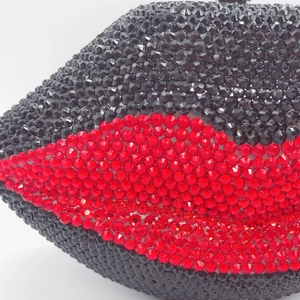 Lip-shaped evening clutch bag with red and black crystals and silver chain strap